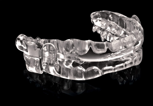 A Promsomnus oral appliance that has been custom fit for a sleep apnea patient